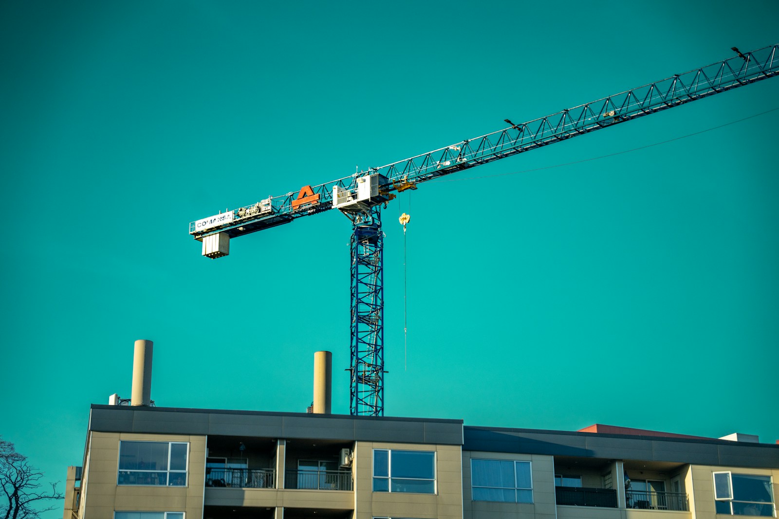 a crane that is on top of a building, constructors equipment